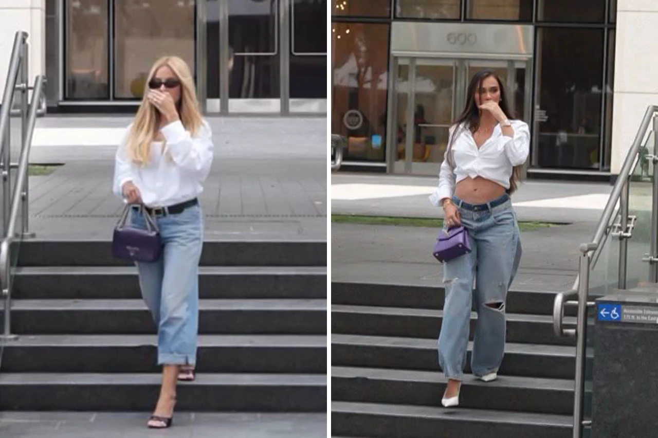 Tainá Militão e Karoline Lima de camisa branca e jeans saindo de um prédio